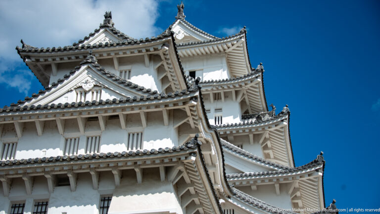 Close view of Himeji Castle's layered keeps and roofs.