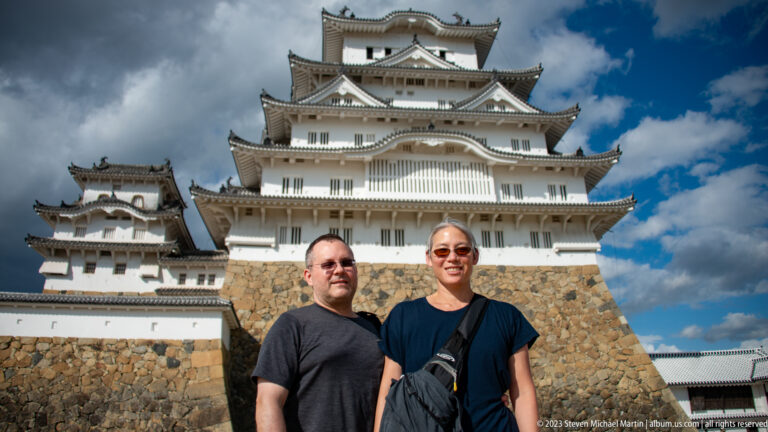 Two visitors posing in front of Himeji Castle.