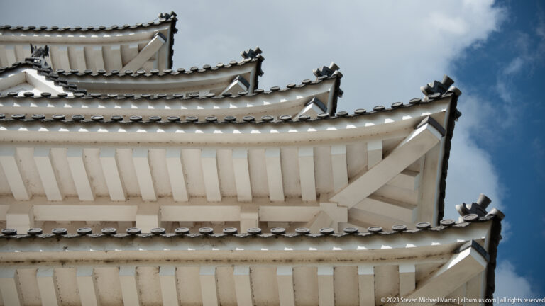 Low-angle view of layered castle eaves.