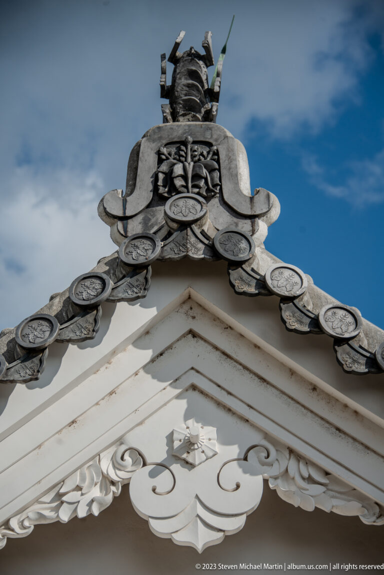 Decorated roof gable with ceramic ridge ornament on Himeji Castle.