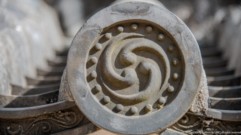 Close-up of a decorative circular roof-end tile.