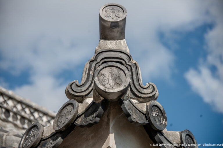 Decorated roof ridge finial against the sky.