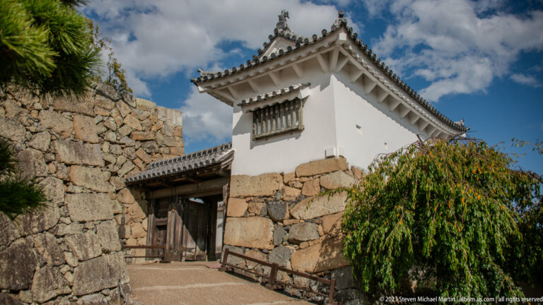 White turret above stone walls at Himeji Castle.