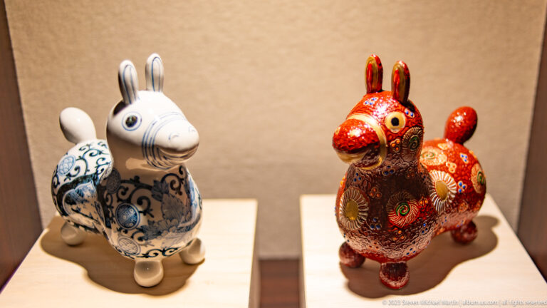 Blue-and-white and red patterned ceramic rabbit figures displayed side by side.