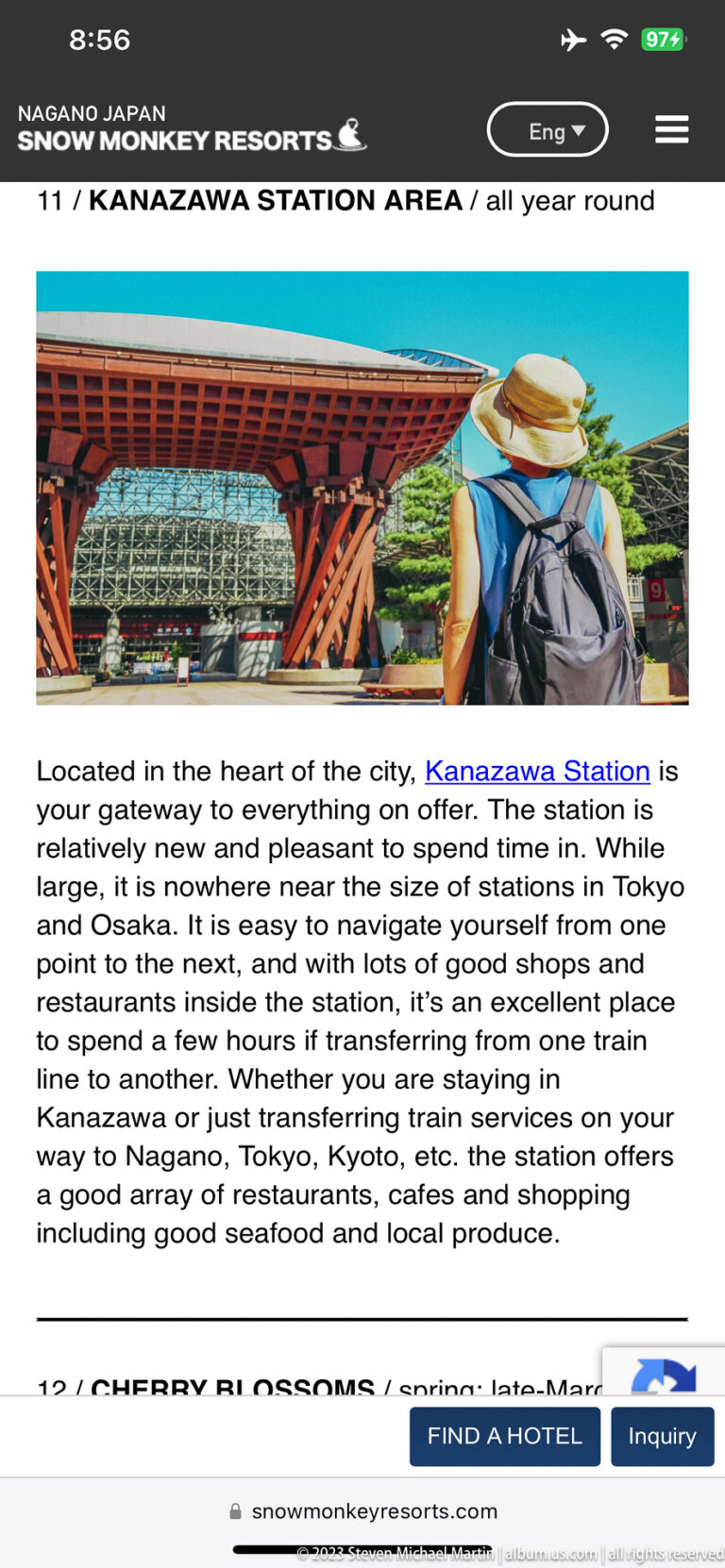 Smartphone screen showing Kanazawa Station’s red timber gate and a tourism article.