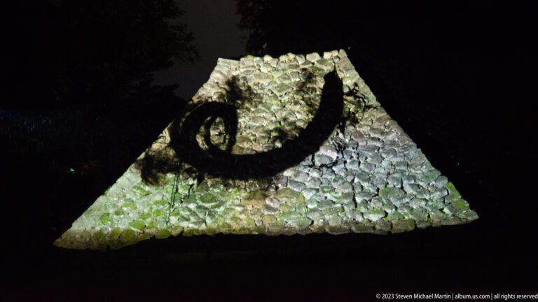 TeamLab’s luminous Zen ensō projected across an old stone wall at Kanazawa Castle.