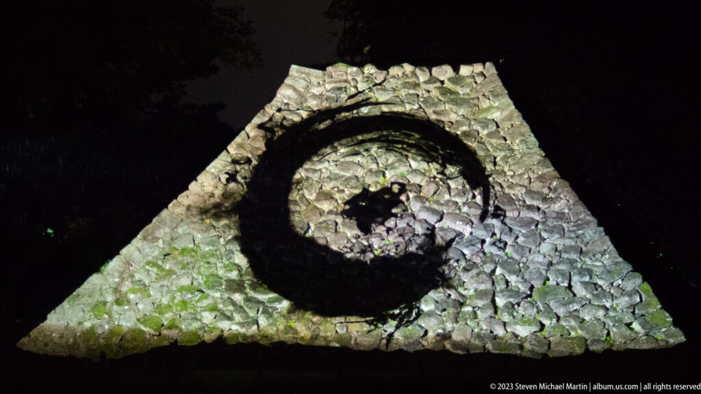 Close view of teamLab’s luminous Zen ensō projected across Kanazawa Castle stonework.