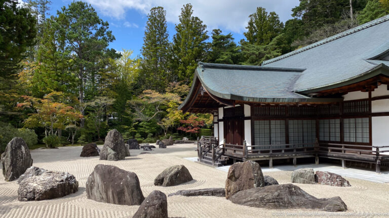 Raked white gravel and clustered stones of Banryūtei beside a wooden temple wing.