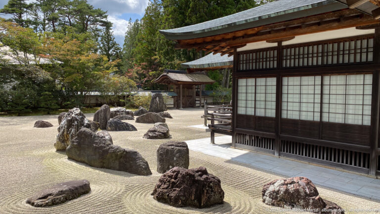 Oblique view of Banryūtei with raked gravel, dark boulders, and a long wooden temple wing.