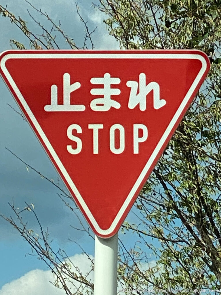 Japanese stop sign reading '止まれ'.