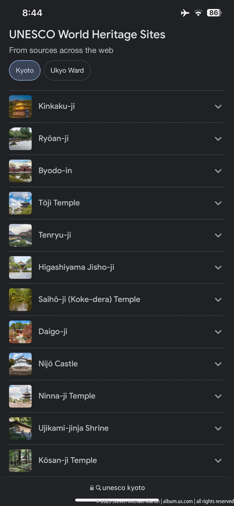 Phone displaying UNESCO Kyoto World Heritage list in its surrounding Kyoto setting.