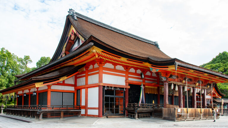 Large Shinto worship hall with sweeping roof and open veranda.