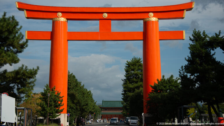 Monumental vermilion Otorii of Heian Jingu spanning Jingu-michi, with the shrine approach beyond.