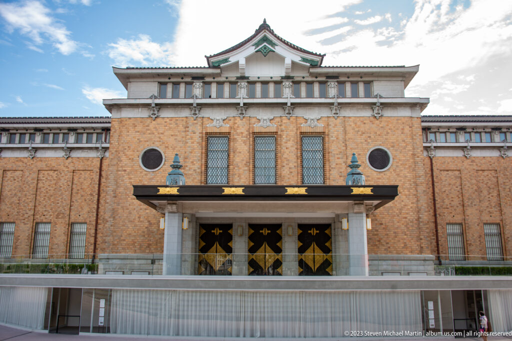 Symmetrical red-brick Meiji Kotokan building at the Kyoto National Museum in its surrounding Kyoto setting.