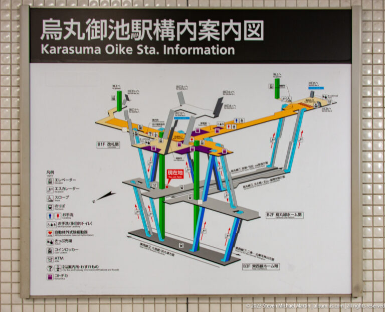 Color-coded multilevel wayfinding map inside Kyoto Station in its surrounding Kyoto setting.