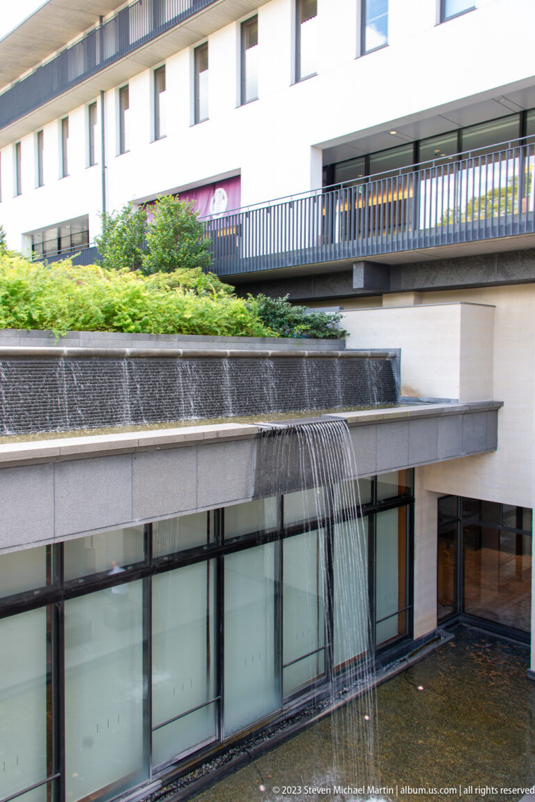Modern building with cascading water feature in its surrounding Kyoto setting.