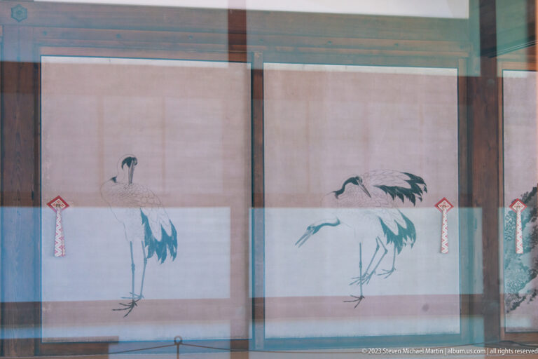 Two cranes painted on pale sliding panels inside Kyoto Imperial Palace.
