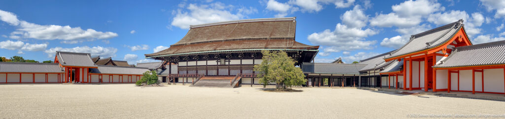 Wide gravel courtyard with a principal palace hall and low surrounding buildings.