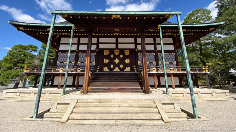 Painted fusuma sliding panels with courtly figures and landscape inside a traditional room.