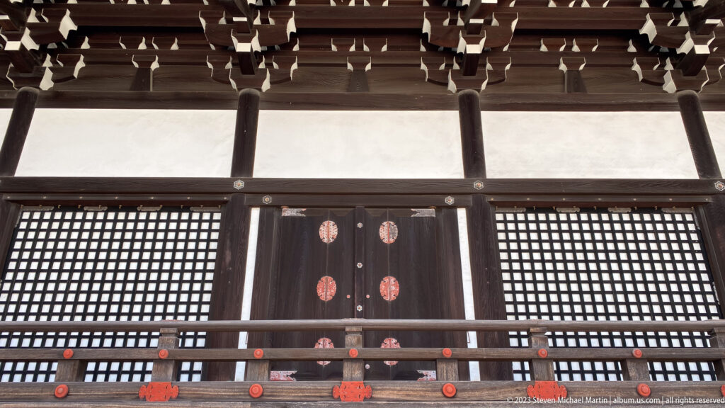Broad timber stairs leading to a covered palace veranda.