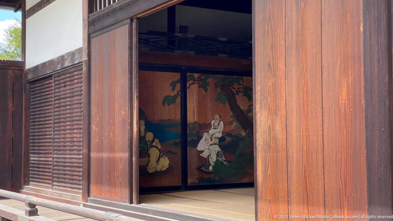 Covered timber corridor with open veranda overlooking the palace grounds.