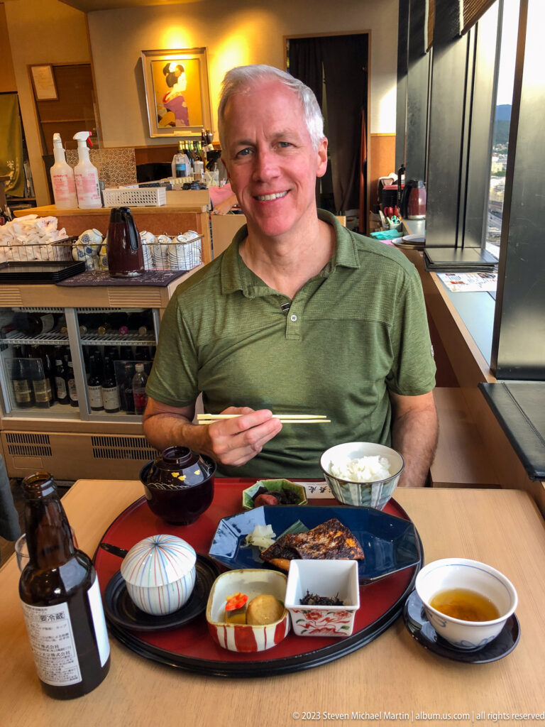 Visitor seated with a traditional Japanese meal in a Kyoto Station restaurant.