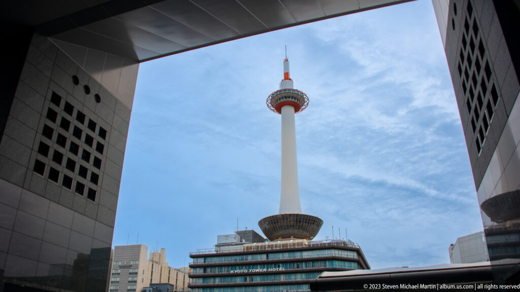 Kyoto Tower framed by the station's modern architecture.