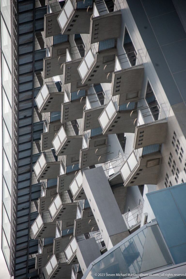 Close view of repeating cantilevered structural elements.