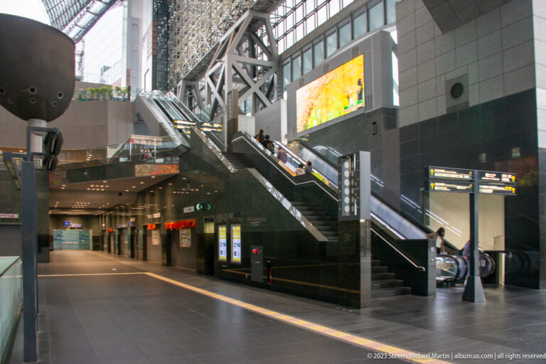 Interior concourse with escalators and structural framing.