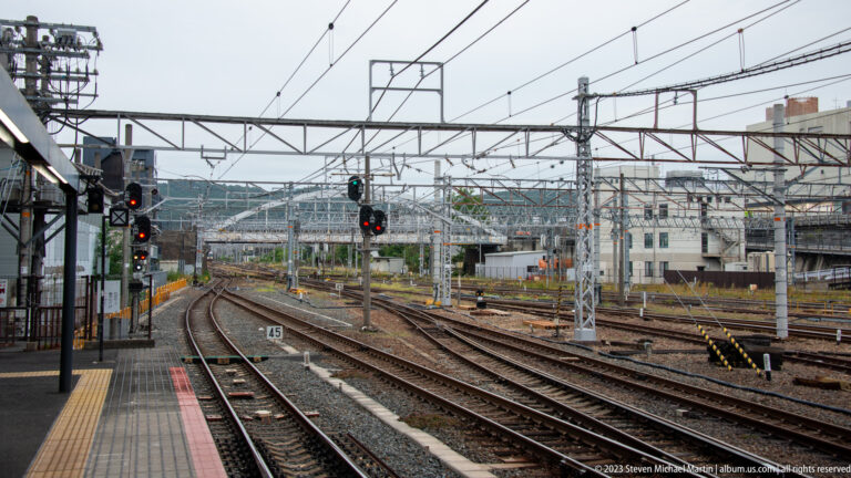 Railway tracks, switches, and overhead power lines outside Kyoto Station.