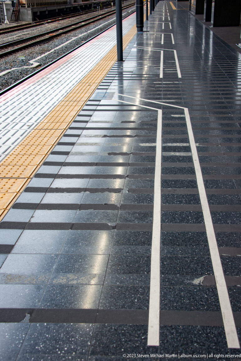 Platform with tactile paving and boarding position markings.