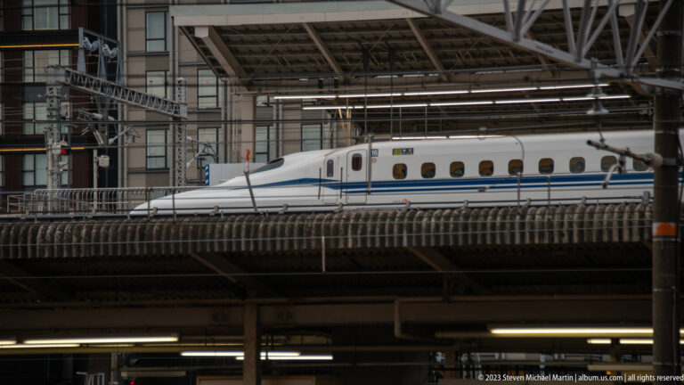 Side view of a Shinkansen train at Kyoto Station.