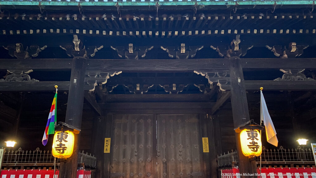 Monumental wooden gate at Tō-ji Temple shown at night with the principal architectural, landscape, or street details visible in the composition.