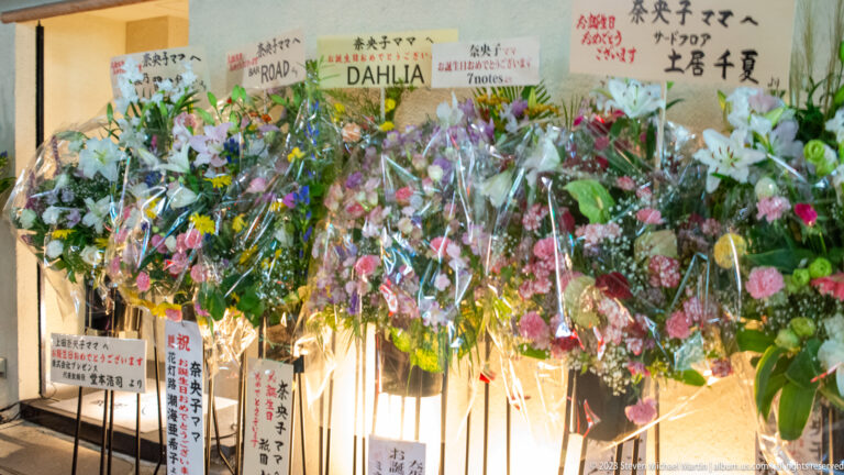 Florist bouquets displayed outside shop shown at night with the principal architectural, landscape, or street details visible in the composition.