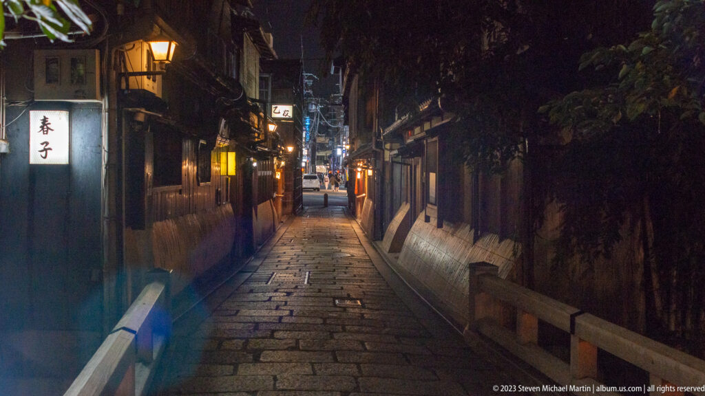 Stone-paved Kyoto alley at night shown at night with the principal architectural, landscape, or street details visible in the composition.