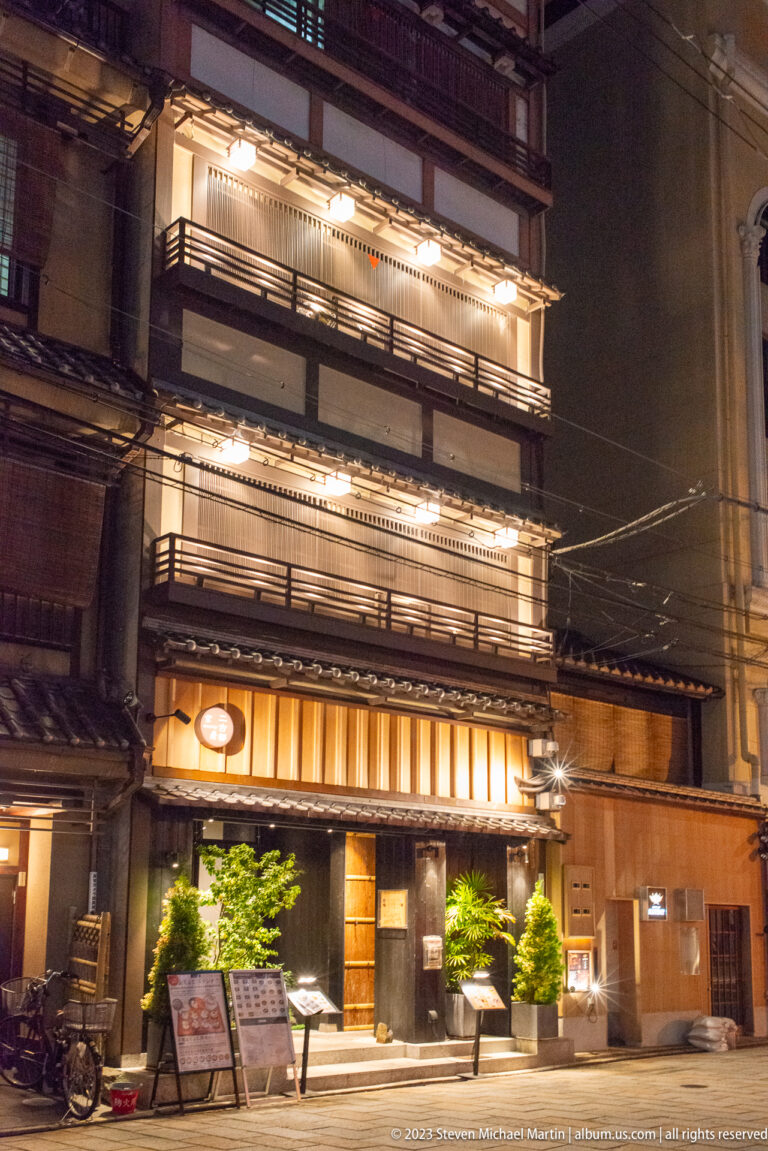 Large illuminated traditional hospitality building shown at night with the principal architectural, landscape, or street details visible in the composition.