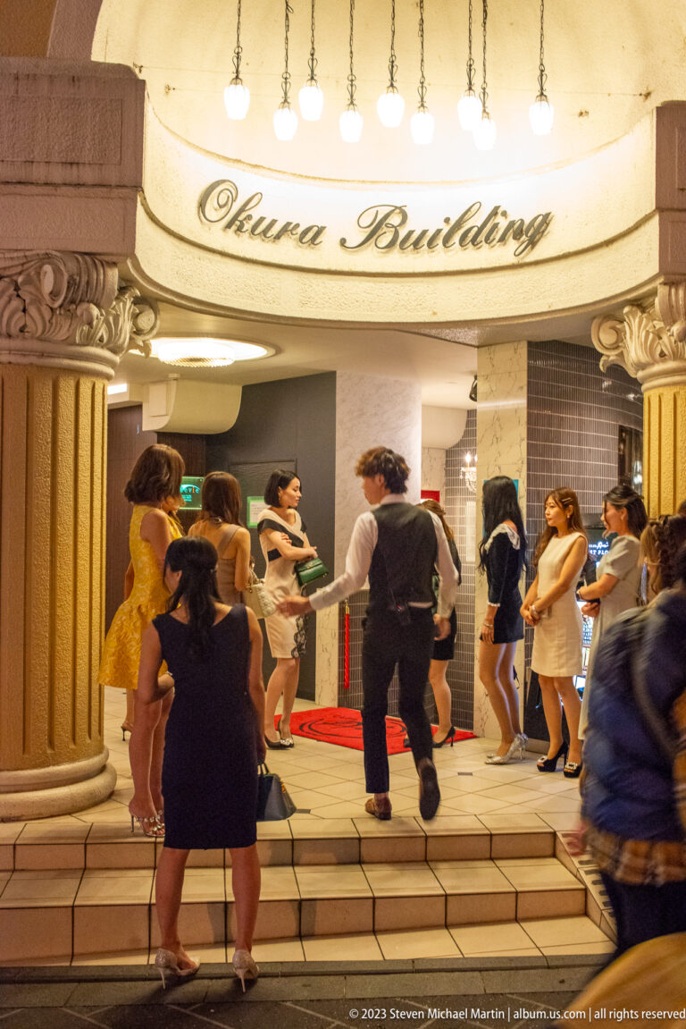 Guests entering Pontocho building shown at night with the principal architectural, landscape, or street details visible in the composition.