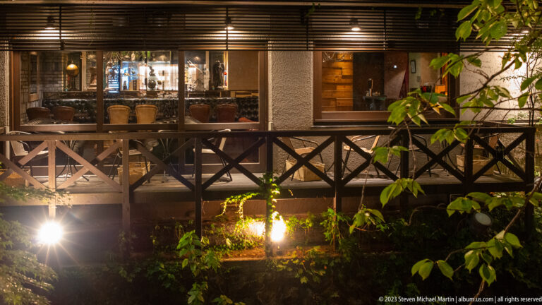 Dining terrace above canal shown at night with the principal architectural, landscape, or street details visible in the composition.