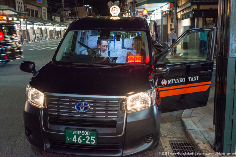 Miyako Taxi picking up passengers shown at night with the principal architectural, landscape, or street details visible in the composition.