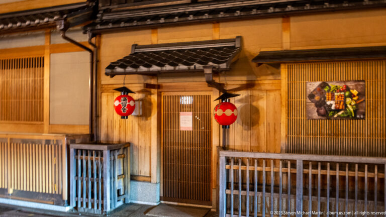 Traditional entrance with twin red lanterns shown at night with the principal architectural, landscape, or street details visible in the composition.