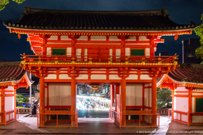 Rear view through Yasaka Shrine gate shown at night with the principal architectural, landscape, or street details visible in the composition.