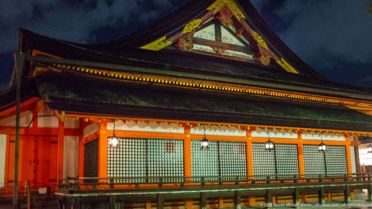 Illuminated Yasaka Shrine hall exterior shown at night with the principal architectural, landscape, or street details visible in the composition.