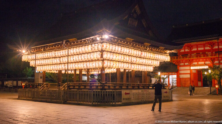 Lantern-covered dance stage (mai-den) at Yasaka Shrine shown at night with the principal architectural, landscape, or street details visible in the composition.