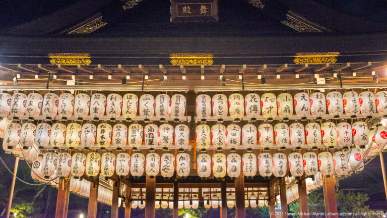 Lantern-covered dance stage (mai-den) at Yasaka Shrine shown at night with the principal architectural, landscape, or street details visible in the composition.