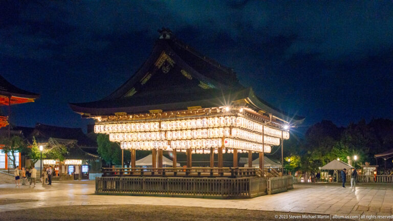 Lantern-covered dance stage (mai-den) at Yasaka Shrine shown at night with the principal architectural, landscape, or street details visible in the composition.