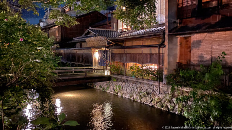 Historic canal lined with traditional buildings shown at night with the principal architectural, landscape, or street details visible in the composition.