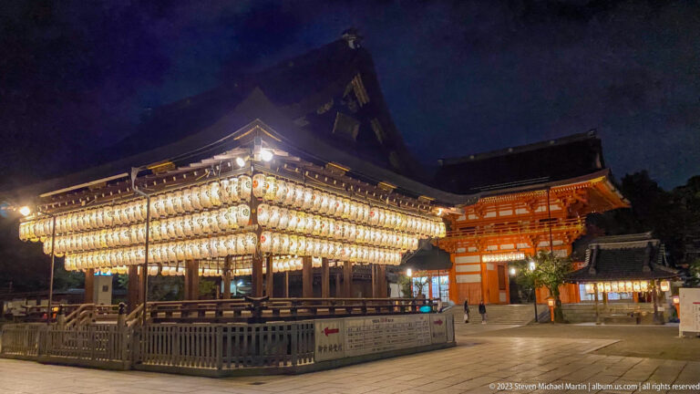 Lantern-covered dance stage (mai-den) at Yasaka Shrine shown at night with the principal architectural, landscape, or street details visible in the composition.