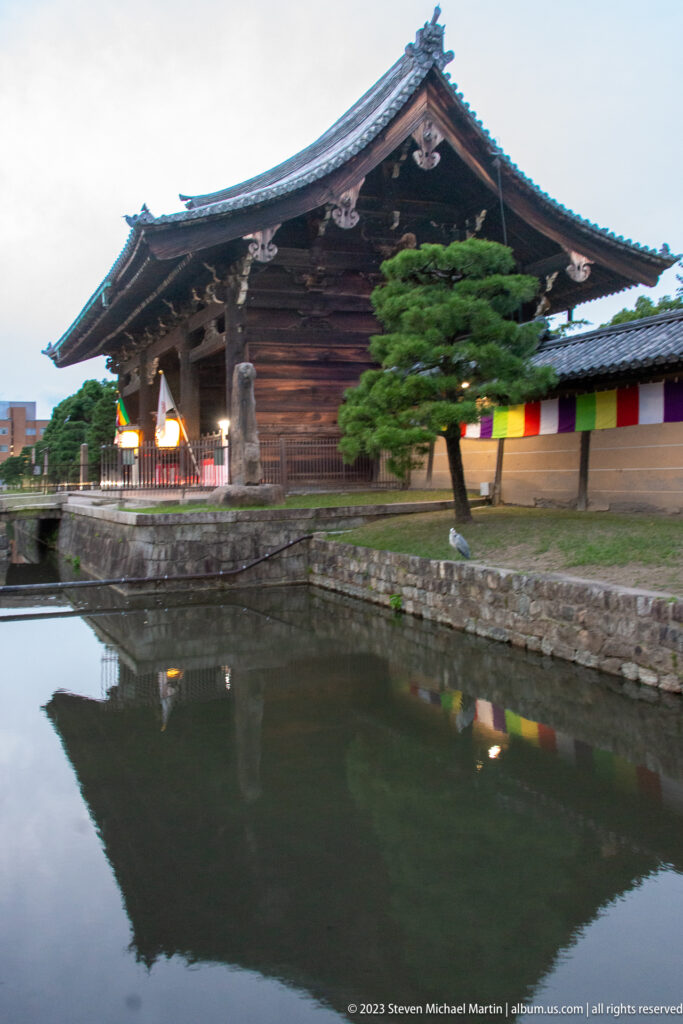 Tō-ji Temple hall reflected in pond shown at night with the principal architectural, landscape, or street details visible in the composition.