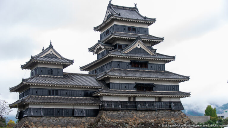 Close exterior view of Matsumoto Castle’s tiered black-and-white main keep.