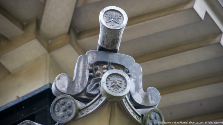 Close-up of stacked ornamental Japanese roof-end tiles with circular crests and curled molded profiles.